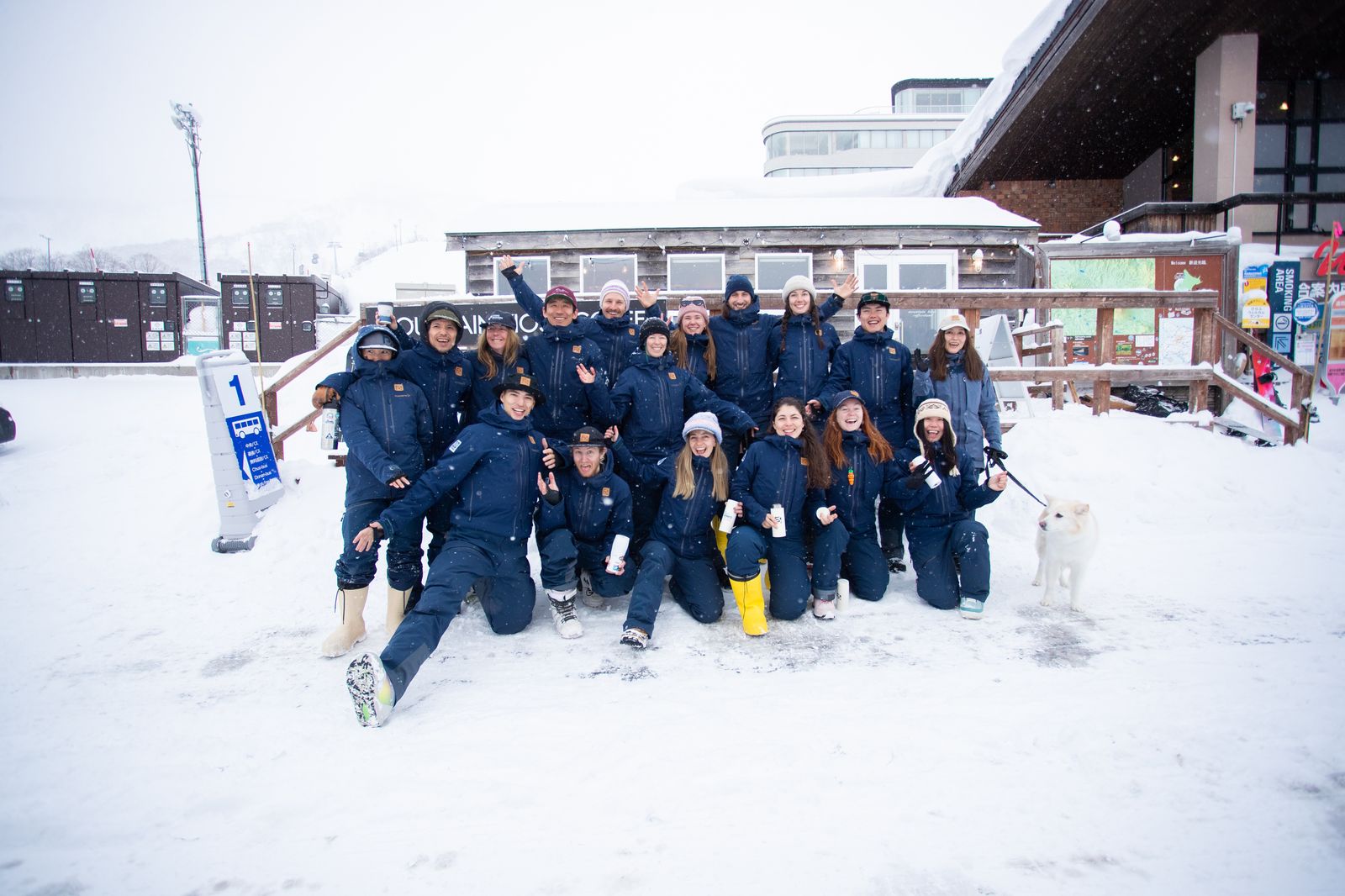 The Far East Snowsports team together at the mountain base in Niseko, with Kuma the dog